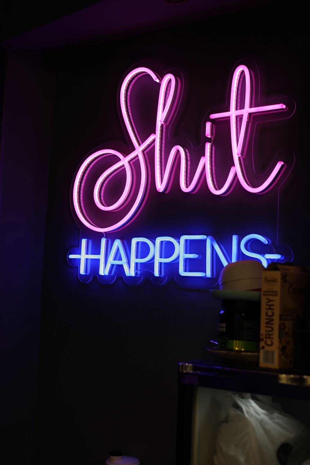 Pink and blue neon sign glowing inside the studio