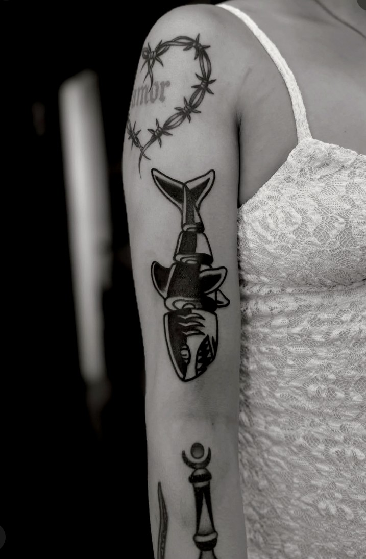 Traditional shark and barbed wire tattoo on upper arm